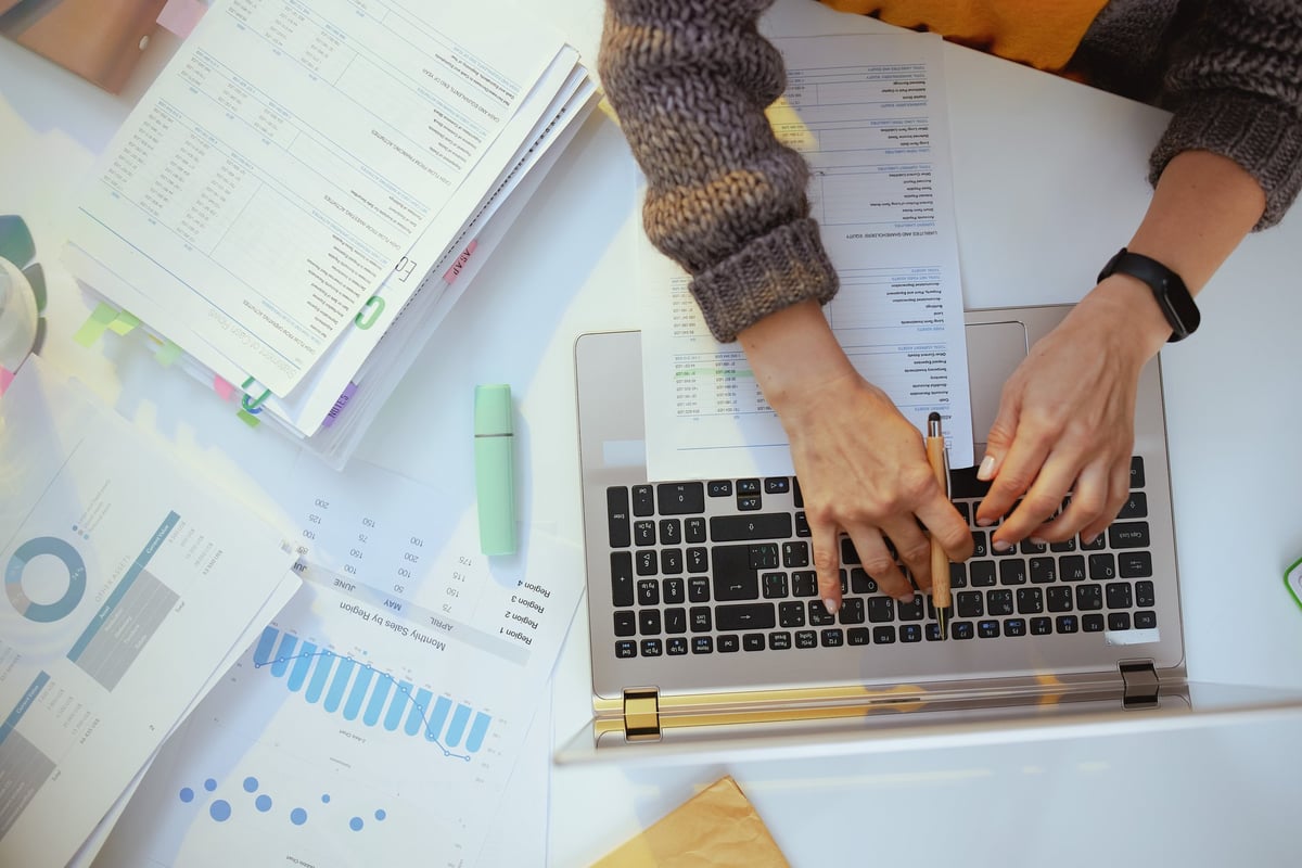 Professional reviewing business documents at a desk